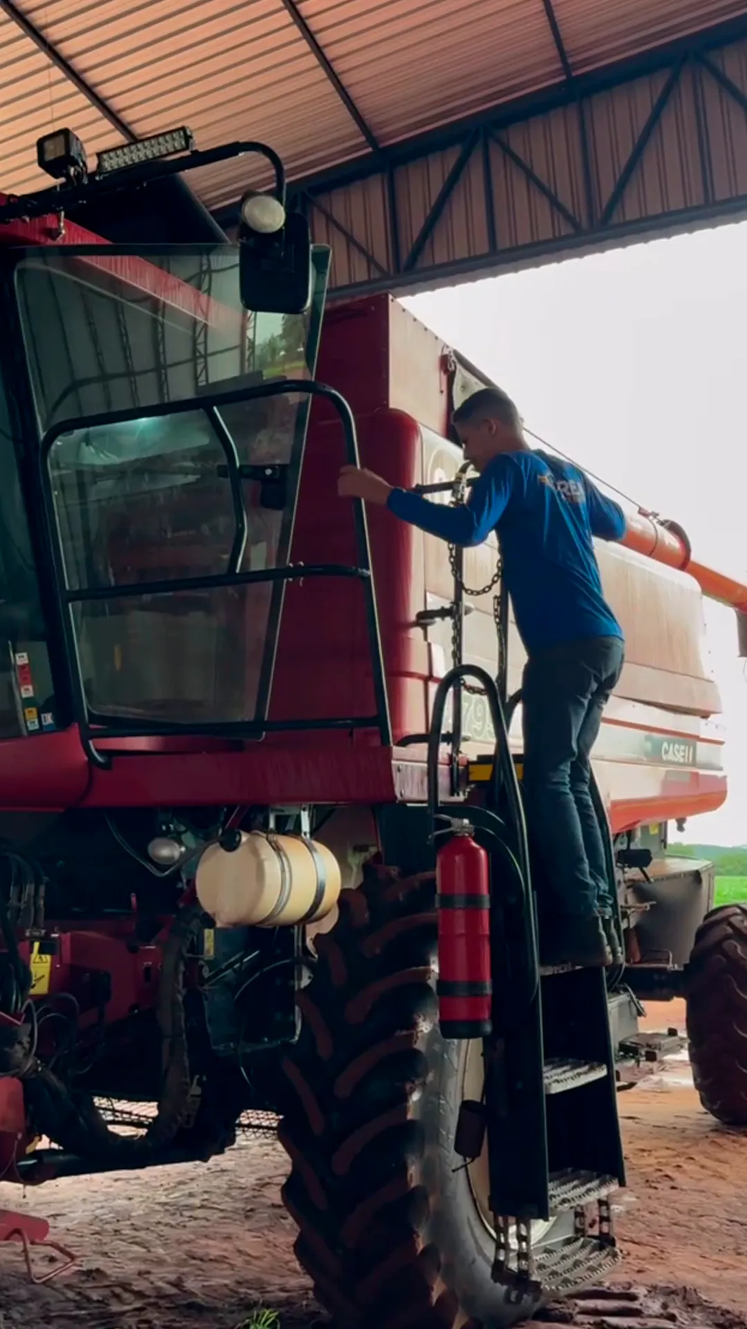 Eletricista subindo na colheitadeira